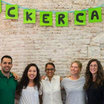 group of interns standing together in front of a brick wall at a local company in barcelona spain