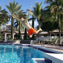 Boy jumping into pool