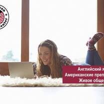Girl reading on her computer laying on stomach 