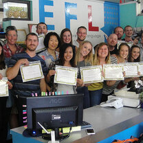 Get Paid to Teach English in Chiang Mai, Thailand Teachers in classroom holding certifications