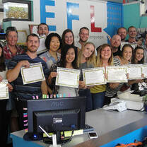 Teachers in classroom holding certifications