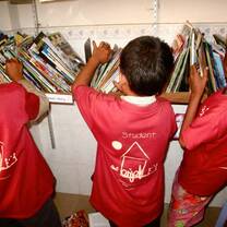 Little kids picking out books 