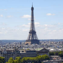 Eiffel tower from a distance with paris buildings around it 