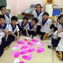 students around a table with arts and crafts 