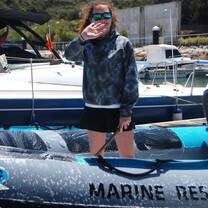 girl smiling on a dingy in the ocean