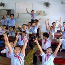 kids in a classroom with their arms up in the air 