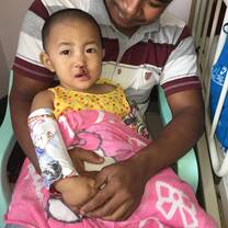 girl smiling with her dad in hospital 