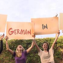 girls holding sign