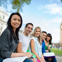 5 people sitting outside and smiling