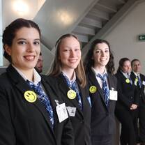 group of young women wearing black suit