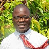 black man wearing eyeglasses and orange tie