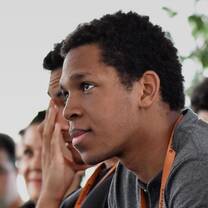 young man listening to his teacher