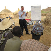 Man explaining something and showing some note to the others