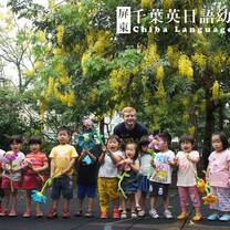 Two men posing with children holding toy flowers.
