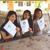 3 young ladies holding their English pronunciation books