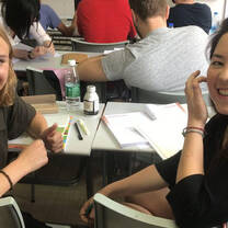 Two girls inside a classroom.