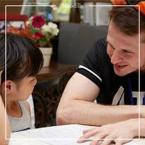 The guy teaching the little girl