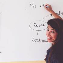 woman writing on the white board
