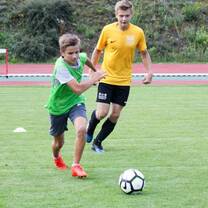 2 boys playing football