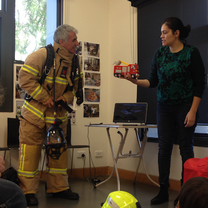 a fire man teaching a girl
