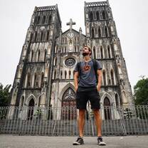 man standing  in front of the church