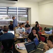 People using laptops inside a room.