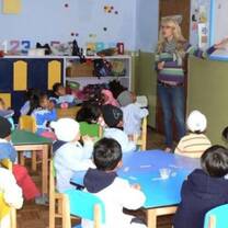 women teaching little kids inside a classroom