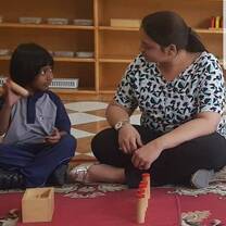 teacher talking to indian boy