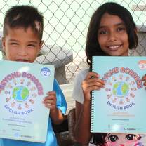Two children holding a book.