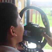 young boy holding a camera close to his face