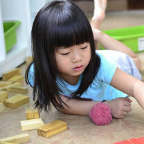 little girl playing blocks