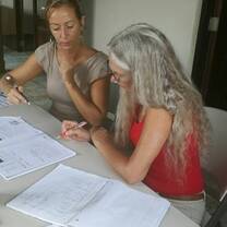 Two ladies talking on something with their notes