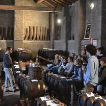 students sitting in a historic building while one gives a speech