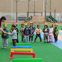 kids playing outside with their teacher