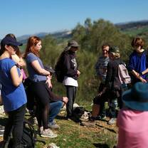group of men and women on top of a hill