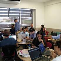 People using laptops inside a room.