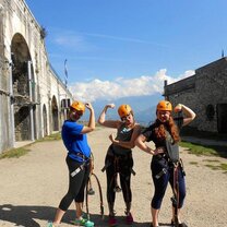 Study Abroad in Grenoble with API! Three people in helmets striking pose with strong arm pose