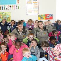 Two volunteers posing with children.