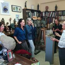 Guy teaching ladies about sculpture.