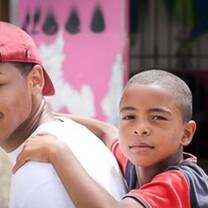  boy riding on the back of a young man