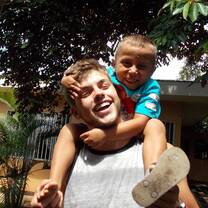 man carrying a young boy on his shoulder