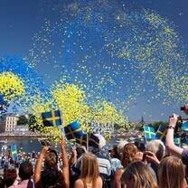 swedish festival with balloons in the air and people celebrating