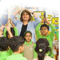 kids playing and singing with their teacher