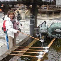 A woman posing with a dragon sculpture 