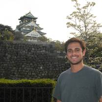 A man posing in front of a monument