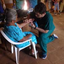 The guy checking the pulse of a old lady