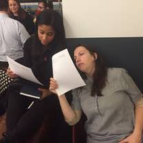 two ladies reading something