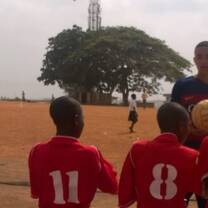 man teaching the teens how to play sports