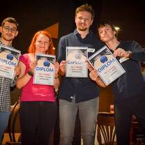 three men and a woman showing their diplomas