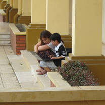 woman teaching child a computer lesson